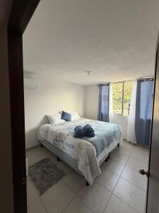 a bedroom with a bed and a window at Modern top floor apartment with pool in San Marcos +23 photos