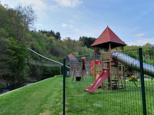 a park with a playground with a slide at Villa Belvedère in Houffalize
