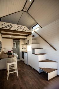 a kitchen with stairs and a table in a tiny house at Dolce Casa 2 by Tiny Away in Rigutino +8 photos