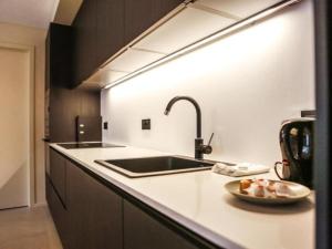a kitchen with a sink and a bowl of food on a counter at Be Durbuy in Durbuy +7 photos