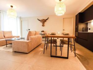 a living room with a table and a couch at Be Durbuy in Durbuy