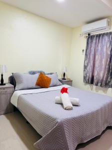 a bedroom with a large bed with towels on it at Nadi Holiday House in Nadi