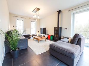 a living room with two couches and a tv at The Green in Durbuy