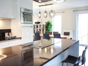 a kitchen and dining room with a table and chairs at The Green in Durbuy