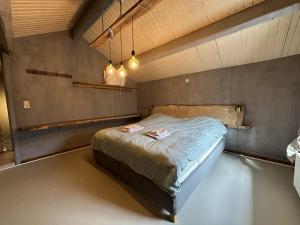 a bedroom with a bed in a room at Le Fournil in Manhay