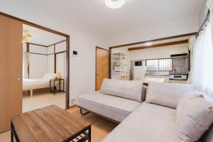 a living room with a couch and a table at Tsuga1976 in Chiba