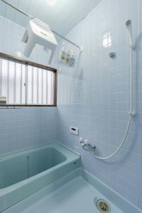 a blue bathroom with a tub and a shower at Tsuga1976 in Chiba +41 photos