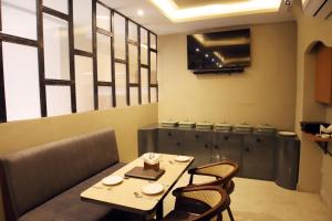 a dining room with a table and chairs at Hotel Ember in Alwar +15 photos