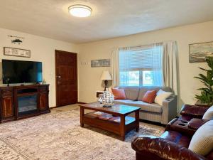 a living room with a couch and a tv at Downtown Duplex A Amazing Location in Sanford