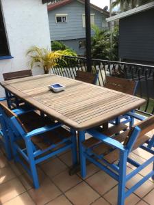a wooden table and chairs on a patio at Villa on Ferguson in Ipswich