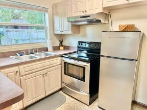 a kitchen with a stainless steel refrigerator and a sink at Downtown Duplex A Amazing Location in Sanford +8 photos