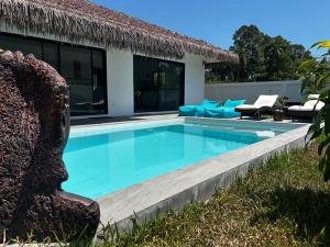 a swimming pool in front of a villa at Villa L Aurora in Taling Ngam Beach