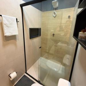 a shower with a glass door in a bathroom at VR VILLAGE - APT 02 - Studio completo próximo ao Shopping da Ilha in São Luís