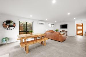 a living room with a table and a couch at The Beach House on Pembrey in Cowes