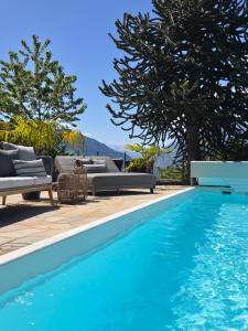 a swimming pool with blue water in a yard at Michael Am Waal in Schenna