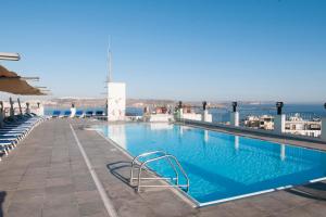 a swimming pool on the roof of a building at Hotel Santana in St. Paul's Bay