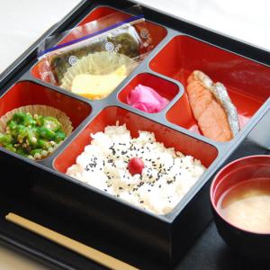 a tray of food with rice and vegetables and chopsticks at Hotel VILLA ANNEX盛岡 in Morioka