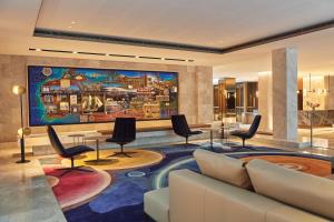 a lobby with a large painting on the wall at Parmelia Hilton Perth in Perth