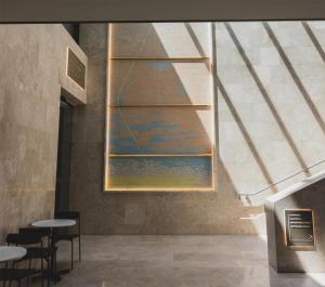 a room with tables and chairs and a painting on the wall at Parmelia Hilton Perth in Perth