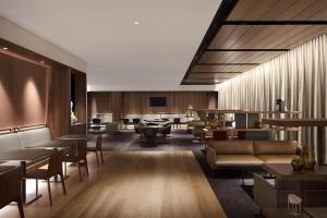 a hotel lobby with tables and couches and chairs at Parmelia Hilton Perth in Perth