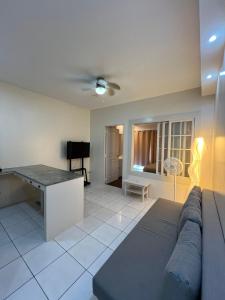 a living room with a couch and a table at STAYLUXIA - MANILABAYVIEW - Luxury and Superior Suites with, Balcony -except Studios- Pool, Netflix & Gym- Housekeeping Available - in Manila