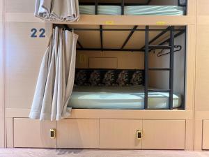 a bunk bed with a window in a bunk room at Urban Capsule by Faradale in Kuching