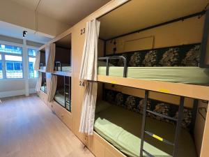 a room with two bunk beds and a hallway at Urban Capsule by Faradale in Kuching