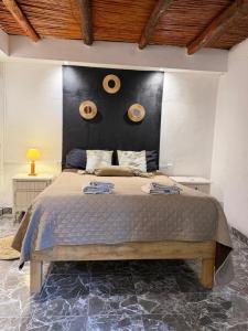 a bedroom with a large bed with two donuts on the wall at Mis Montañas in Tinogasta