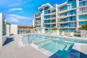 an image of a swimming pool in front of a building at Dwell Apartment 33 in Bargara