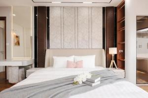 a bedroom with a bed with books and flowers on it at Santori studio Hanoi in Hanoi