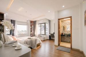 a bedroom with a bed and a desk and a mirror at Santori studio Hanoi in Hanoi