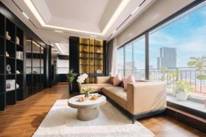 a living room with a couch and a large window at Santori studio Hanoi in Hanoi