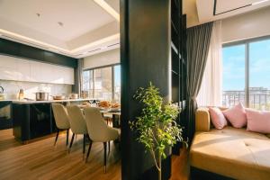 a kitchen and living room with a couch and a table at Santori studio Hanoi in Hanoi