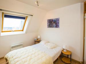a white bedroom with a bed and a window at Villa Nova - 0402 + box 24 in Middelkerke