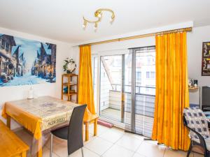 a dining room with a table and a window at Villa Nova - 0402 + box 24 in Middelkerke +6 photos