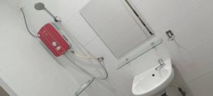 a bathroom with a toilet and a sink at Elite Hotel in Kuantan +15 photos
