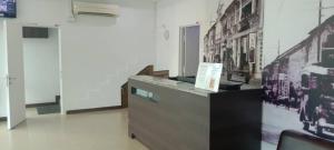 a room with a counter with pictures on the wall at Elite Hotel in Kuantan