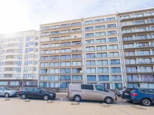 a large building with cars parked in front of it at Rubens - 0505 in Middelkerke