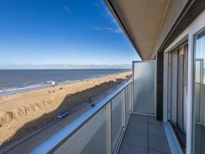 a balcony with a view of the beach at Romanza - 0405 + park.38 in Middelkerke