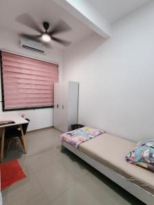 a bedroom with a bed and a pink door at Atabara ECRL Stay Homestay in Kuantan