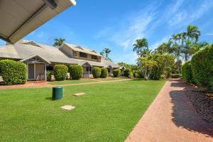 a house with a green yard with a pathway at Sunset Escape in Broome