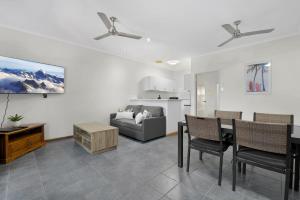 a living room with a table and a couch at Sunset Escape in Broome
