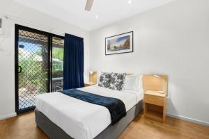 a bedroom with a bed and a large window at Sunset Escape in Broome +7 photos