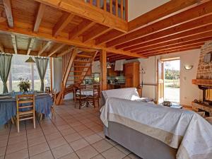 a bedroom with a bed and a dining room with a table at Gîte rustique 6 pers avec cheminée et grand jardin, animaux acceptés - FR-1-496-61 in Les Salles