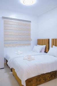 two beds sitting next to each other in a bedroom at perle de dakhla in Dakhla +22 photos