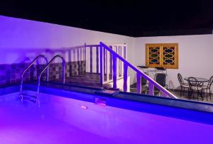 a swimming pool with purple lighting in a house at perle de dakhla in Dakhla