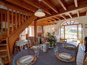a dining room with a table in a house at Gîte rustique 6 pers avec cheminée et grand jardin, animaux acceptés - FR-1-496-61 in Les Salles +22 photos