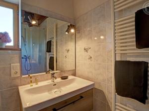a bathroom with a sink and a mirror at Gîte rustique 6 pers avec cheminée et grand jardin, animaux acceptés - FR-1-496-61 in Les Salles
