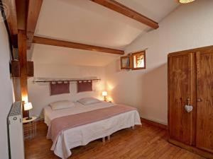 a bedroom with a large bed in a room at Gîte rustique 6 pers avec cheminée et grand jardin, animaux acceptés - FR-1-496-61 in Les Salles