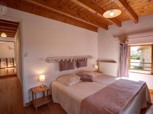 a bedroom with a large bed and a window at Gîte 4 pers avec jardin privé et animaux admis - FR-1-496-66 in Les Salles